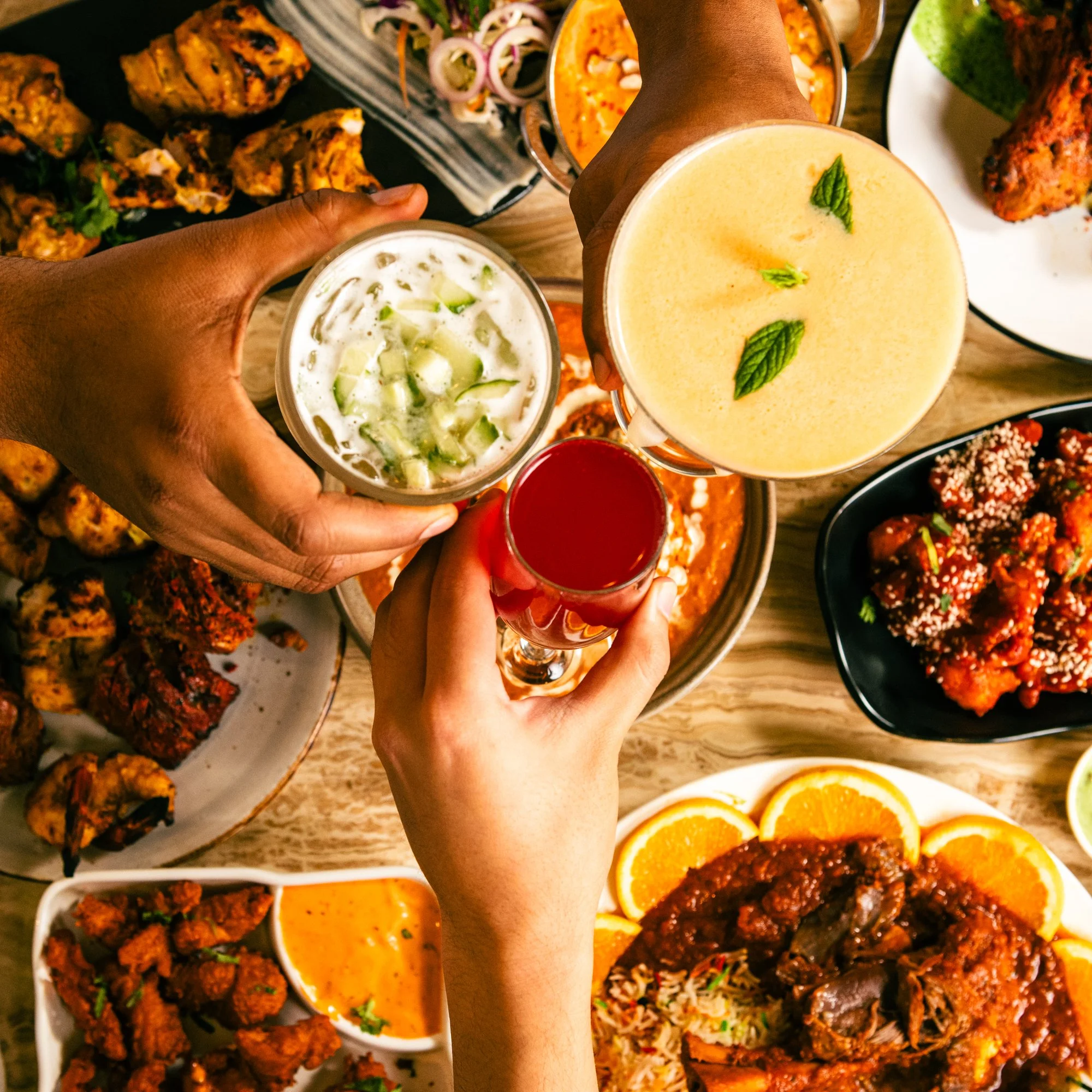 Friends toasting over a table of dishes