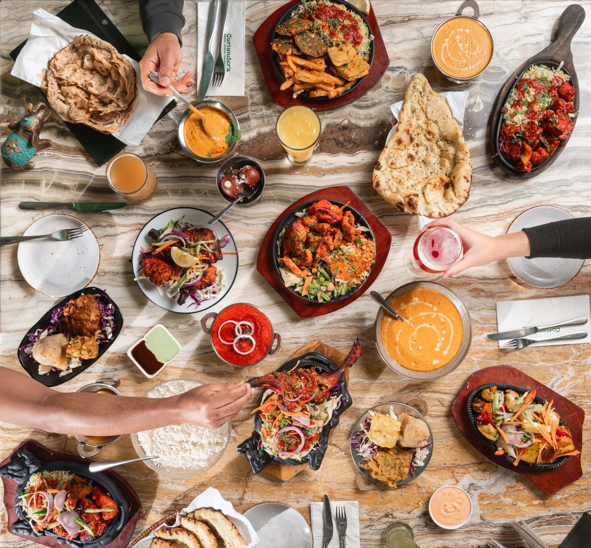 A spread of dishes from both kitchens, plated across the pass