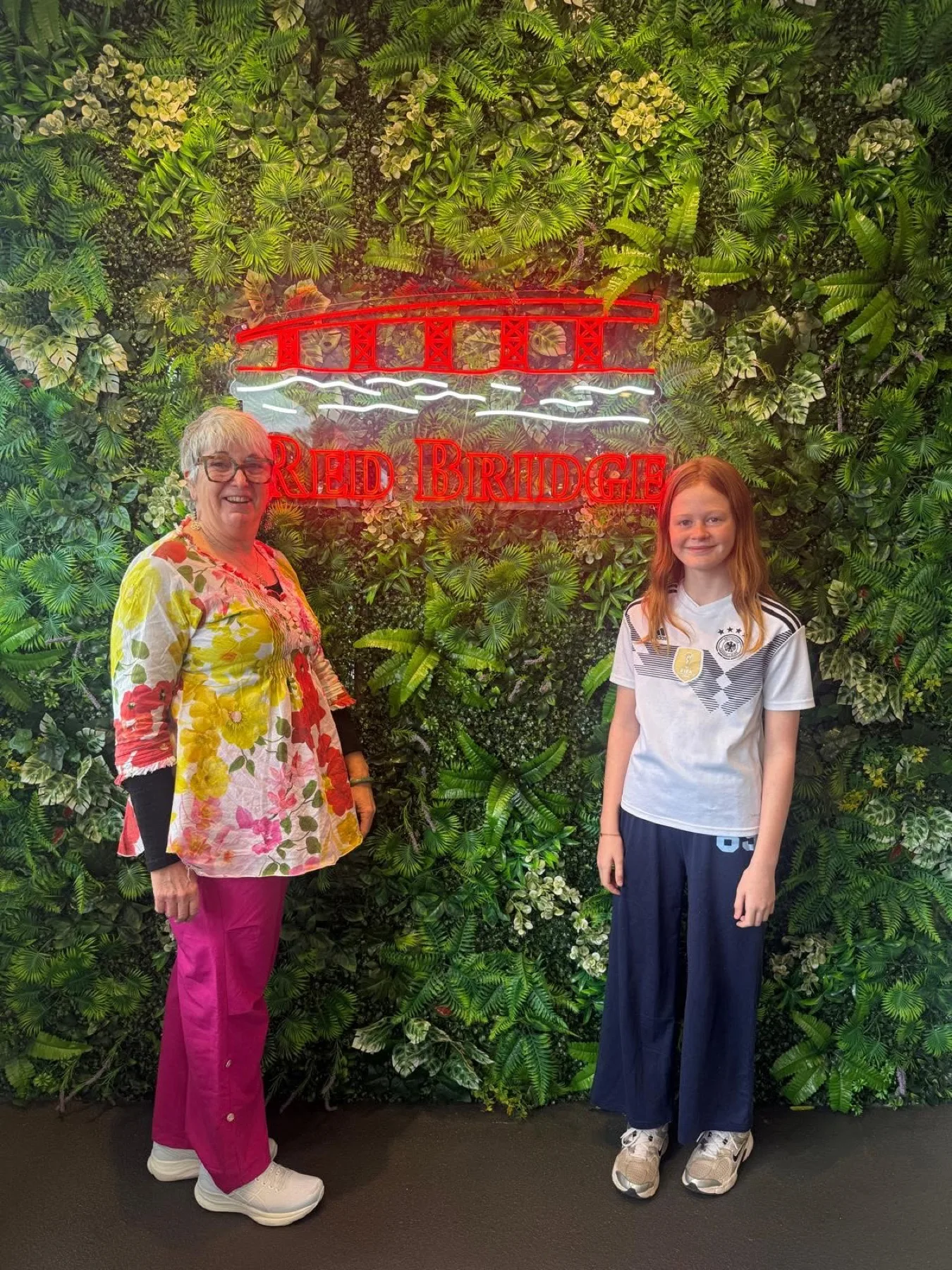 Two of our longest-loved team members at the green wall